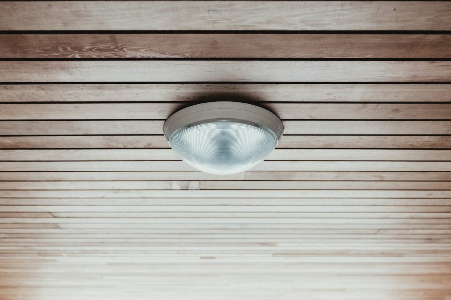 Elektroarbeiten in Goch kurzfristig erledigt Decke mit Holzpaneelen und einer runden, weißen Deckenleuchte.